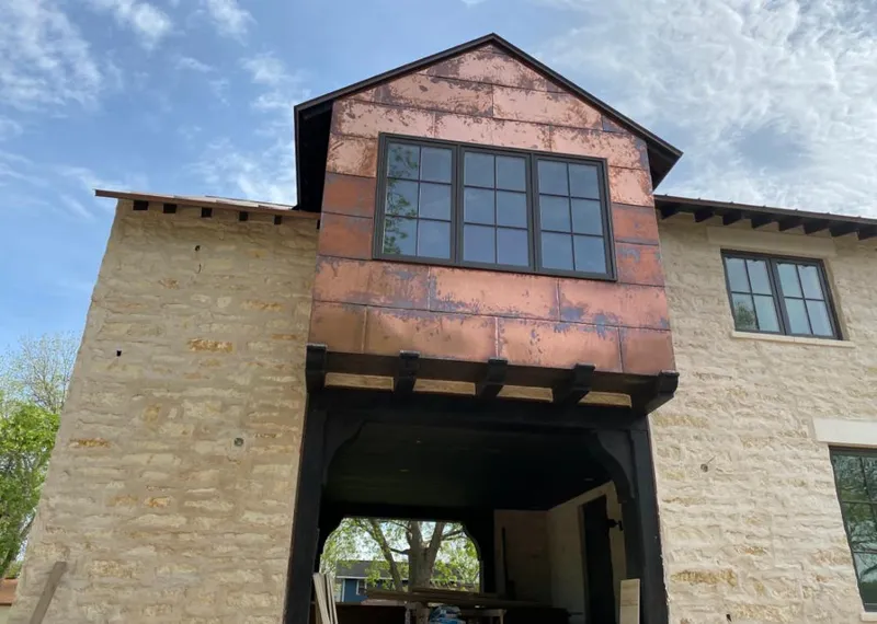 Copper metal panel facade on a stone building for Skylight Installation in Hendersonville